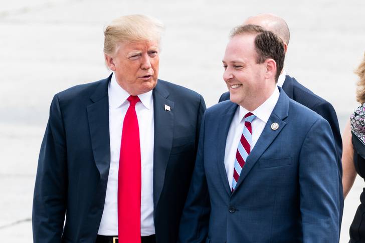 Donald Trump, on the left in a red tie, walking alongside Rep. Lee Zeldin